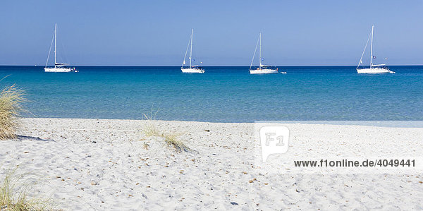 Boots anchored in front of dune beach of Porto Pino  Sardinia  Southern Coast  Italy  Europe