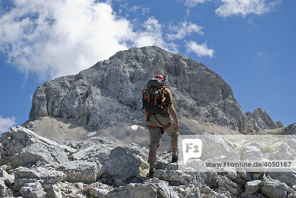 Hiker in front of the peak of Mount Triglav  Julian Alps  Slovenia  Europe