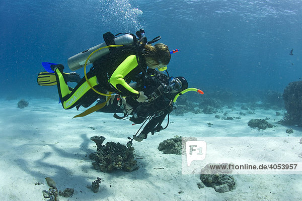 Scuba diving teacher with a child doing the diver's quaification in the sea  Indonesia  Southeast Asia