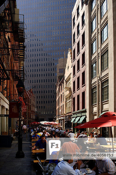 Busy street eateries during lunch time in Downtown  skyscrapers at back  New York City  USA