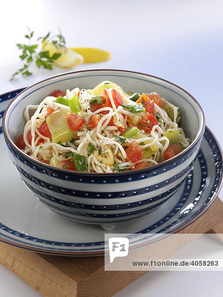 Rice noodle salad with capsicum in a blue and white bowl