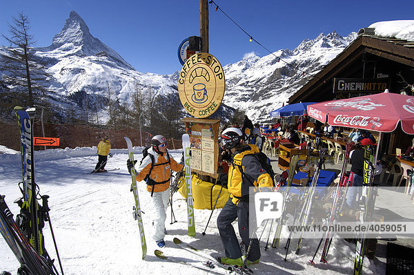 Skiers in front of the Chemi-Hitta mountain hut  Matterhorn Mountain  Zermatt  Valais or Wallis  Switzerland  Europe