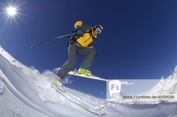 Skier skiing down the Riffelberg Mountain in front of the Matterhorn Mountain  Zermatt  Valais or Wallis  Switzerland  Europe