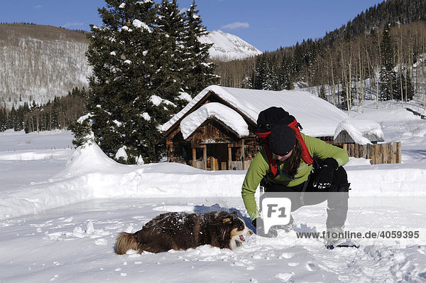 Female snow shoe hiker with dog  Dunton Hot Springs Lodge  Colorado  USA