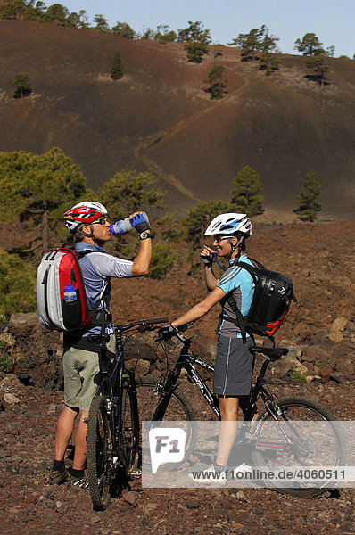 Bicyclists in the country terrain taking a break  Tenerife  Canary Islands  Spain  Europe