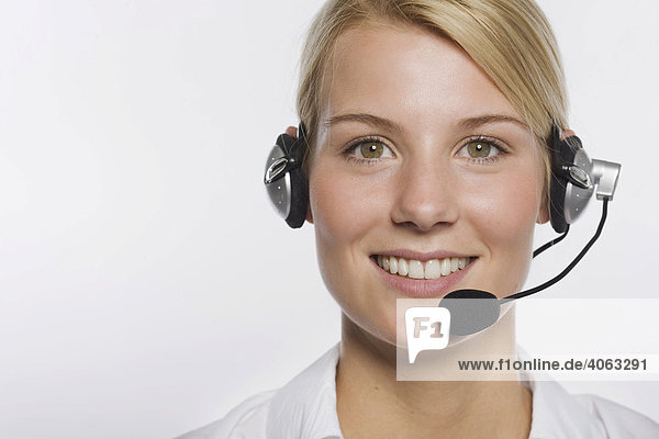 Young blond woman wearing a headset
