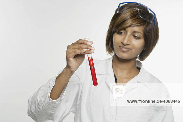 Laboratory worker holding up a test tube