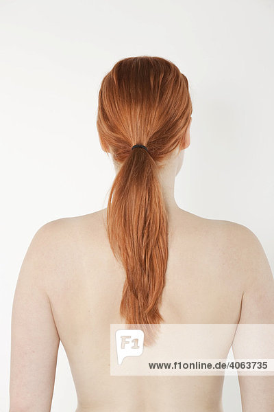 Back view of a young red-haired woman with a pony tail
