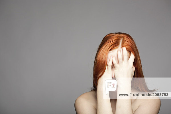 Young  red-haired woman  distressed  sad