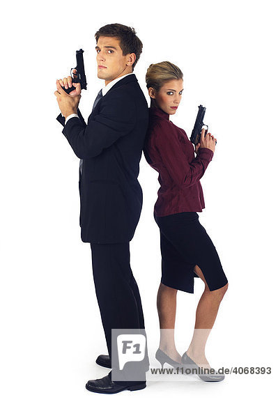 Man and woman holding guns  standing back to back