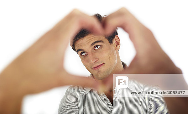 Hands forming the shape of a heart  framing a man