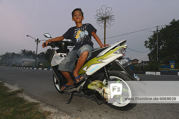 Boy on a scooter  Pangkalanbun  Central Kalimantan  Borneo  Indonesia  Southeast Asia