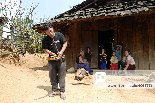 Hmong musician playing the flut in the village  a traditional instrument  Phakeo  Xieng Khuang Province  Laos  Southeast Asia