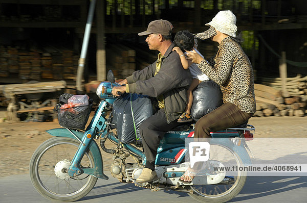 Crammed full motocycle with people and luggage  near Phnom Penh  Cambodia  Southeast Asia