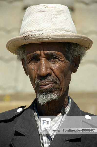 Guard wearing a white hat and uniform  portrait  Axum  Ethiopia  Africa