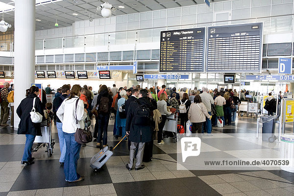 Passengers in a queue at the security check  Munich Airport  Bavaria  Germany  Europe