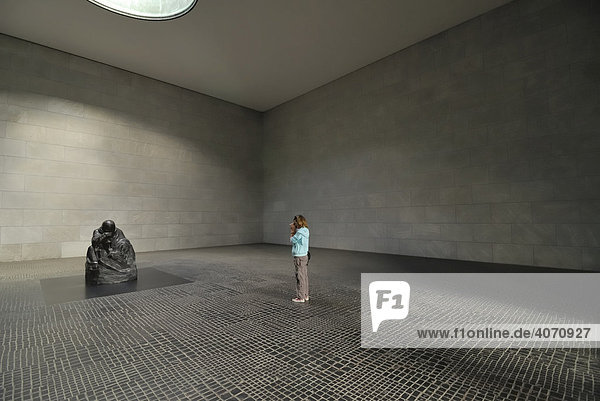 Young girl taking a photograph of the statue MOTHER WITH HER DEAD CHILD by Kaethe Kollwitz  Berlin  Germany  Europe
