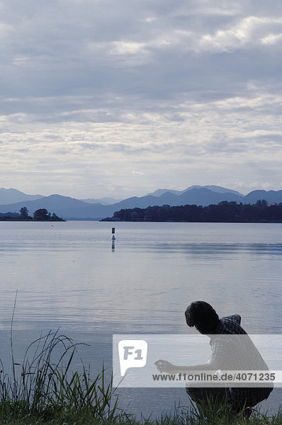 Daybreak on the lake with a person  Chiemsee Lake  Upper Bavaria  Germany  Europe