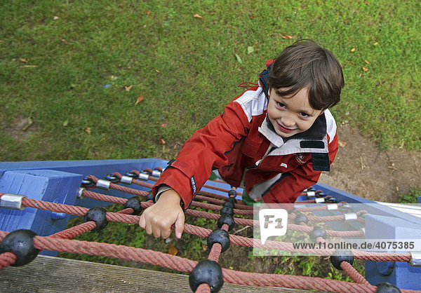 Child climbing in a playground  Niederwerth  Rhineland-Palatinate  Germany  Europe