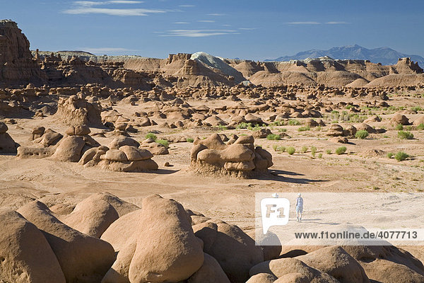 Two women hiking in Goblin Valley State Park  where sandstone has eroded into unusual shapes  Green River  Utah  USA