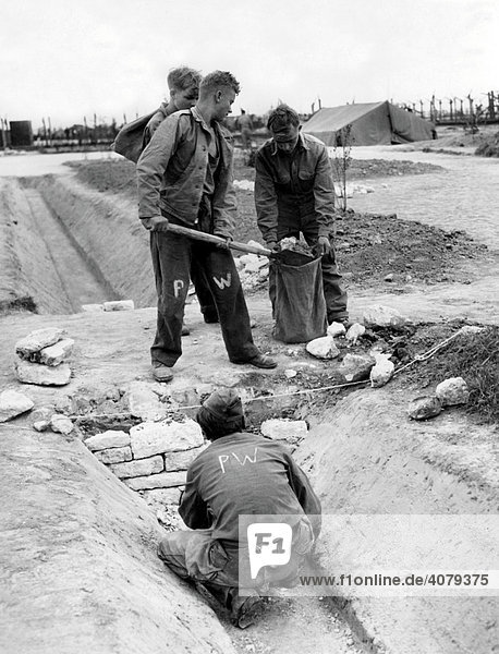 Four prisoners of war working  PW  abbreviation of prisoner of war  historical photo  1945  Holland  Europe