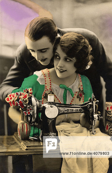 Historic photo  couple with sewing machine  ca. 1920