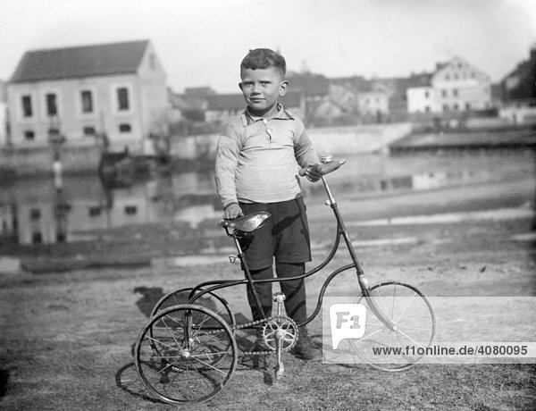 Historic photograph  child with a tricycle  around 1920