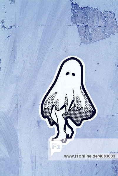 A sticker of a little funny ghost at a wall.