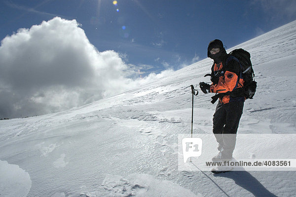 Bergsteiger in Eis und Schnee mit Wolken und Sonne Kharkhiraa Uul Mongolischer Altai bei Ulaangom Uvs Aimag Mongolei