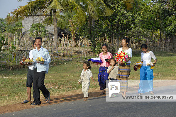 Happy people in traditional dress on their way to a wedding near Skun Cambodia