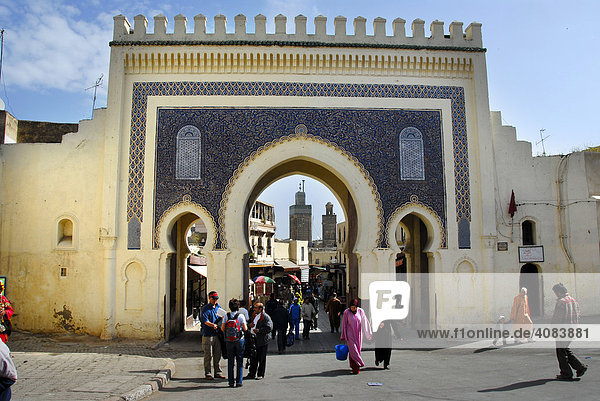 People walk through the beautiful oriental gate into the city center Bab Bou Jeloud Fes El-Bali Morocco