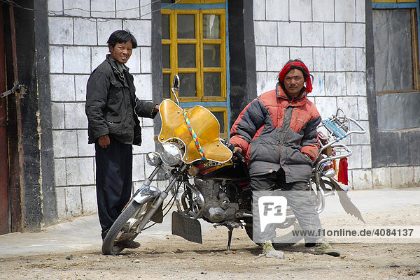 Tuff guys Tibetan men with motorbike Phodo Dzong Tibet China