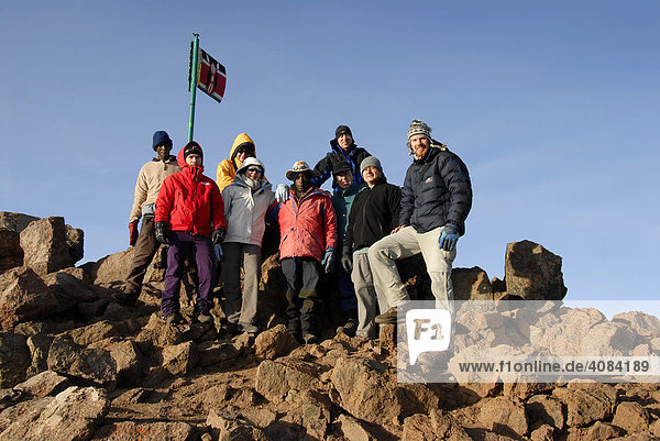 Group of mountaineerers at rocky summit Point Lenana (4985 m) Mount Kenia National Park Kenya
