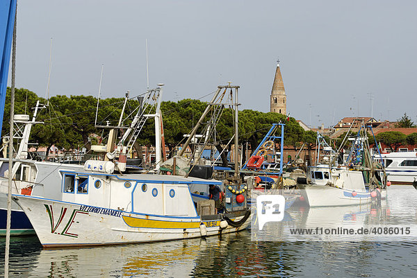 Caorle at the Adria region Veneto Italy at the fishing harbour with the church