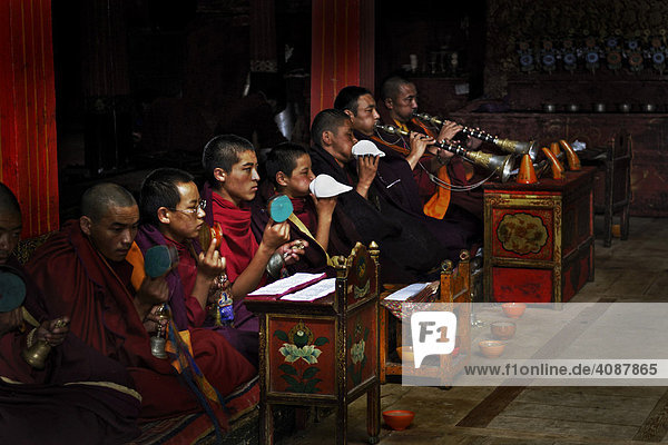 Monks of the black cap order with wind instruments  Tshurpu Convent near Lhasa  Tibet