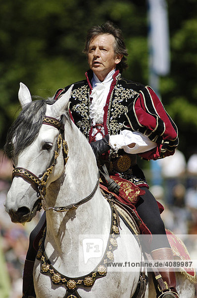 Nobleman in mediaeval medieval costume rides on white horse  knight festival Kaltenberger Ritterspiele  Kaltenberg  Upper Bavaria  Germany