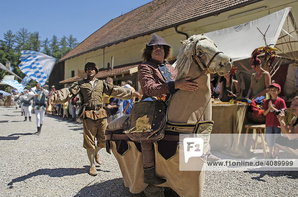 Man with mediaeval medieval costume riding on a horse dummy  knight festival Kaltenberger Ritterspiele  Kaltenberg  Upper Bavaria  Germany