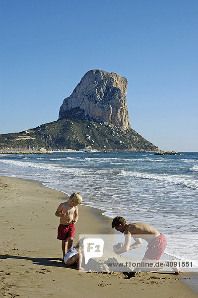 Father with children plays at the beach of Calpe  Penon de Ifach  Costa Blanca  Spain
