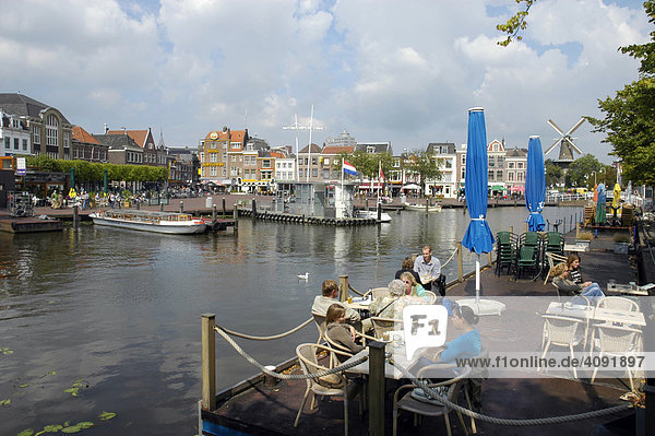 Guests sitting in a restaurant at a canal  Leiden  South Holland  Holland  The Netherlands
