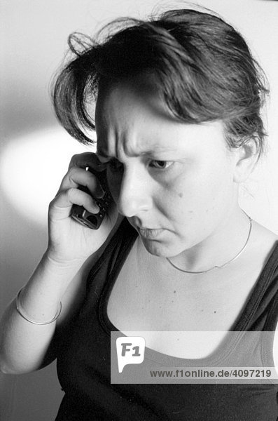 Woman on cellular phone worry