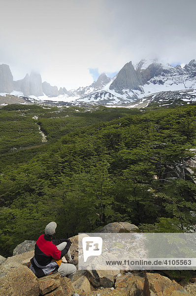 Trekker watching the Cuernos del Paine in the clouds  Torres del Paine National Park  Patagonia  Chile (Torres del Peine)