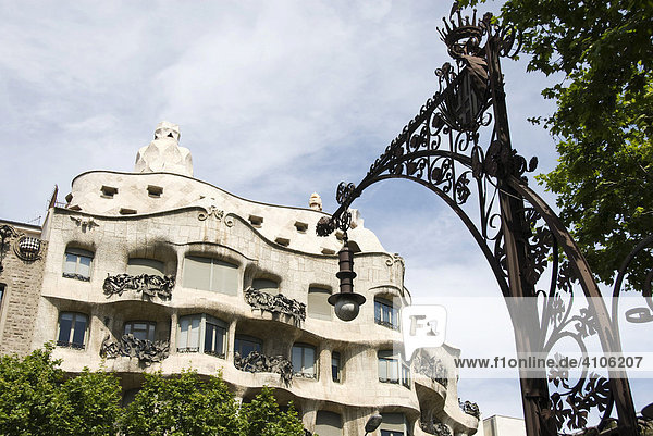 Fassade der Casa Milà des Architekten Antoni Gaudí  auch La Pedrera  der Steinbruch  und Straßenlaterne von Pere Falqués i Urpí am Passeig de Gràcia  Stadtteil Eixample  Barcelona  Spanien  Europa