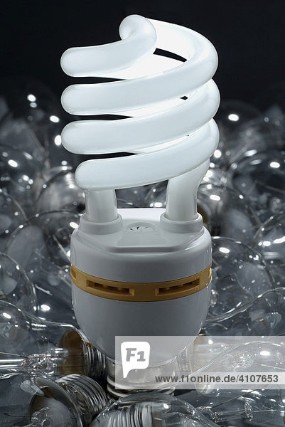 Energy efficient lightbulb surrounded by tungsten lightbulbs