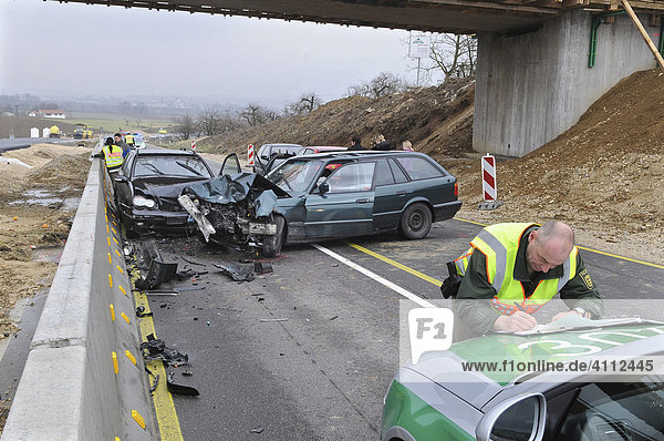 Police officer during the acquisition of accident data of a car accident Nuertingen Esslingen Region Baden-Wuerttemberg Germany Europe