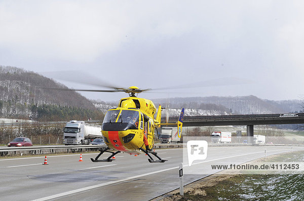 The ADAC German auto club air rescue helicopter Christoph 22 taking off to hospital from autobahn or motorway A8 after a deadly vehicular accident near Gruibingen  Baden-Wuerttemberg  Germany  Europe