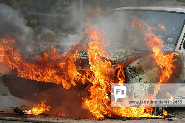 Burning car training for the FFW Owen auxiliary or volunteer fire brigade at the Leuze Electronic Company Braike Industrial Zone Owen Esslingen Region Baden-Wuerttemberg Germany Europe