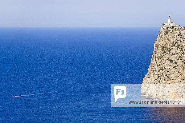A boat passes the Cap de Fortmentor  Majorca  Balearic Islands  Spain