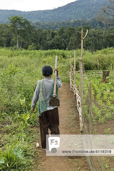 Farmers woman with hoe on the way to the field  Koh Kong Province  Cambodia