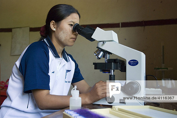 Blood test on Malaria with microscope in the lab  Kou Kou Clinic  Swe Kou Kou village  IDP-Area bordering Thailand near Maesot  Birma