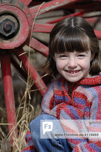 Young girl - Fall season portrait  old wagon wheel